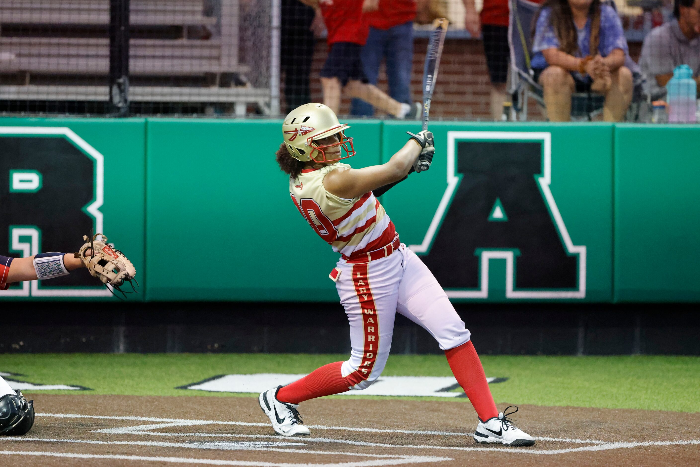 South Grand Prairie’s Jasmyn Lloyd (20) watches after she drove in three-runs against Allen...