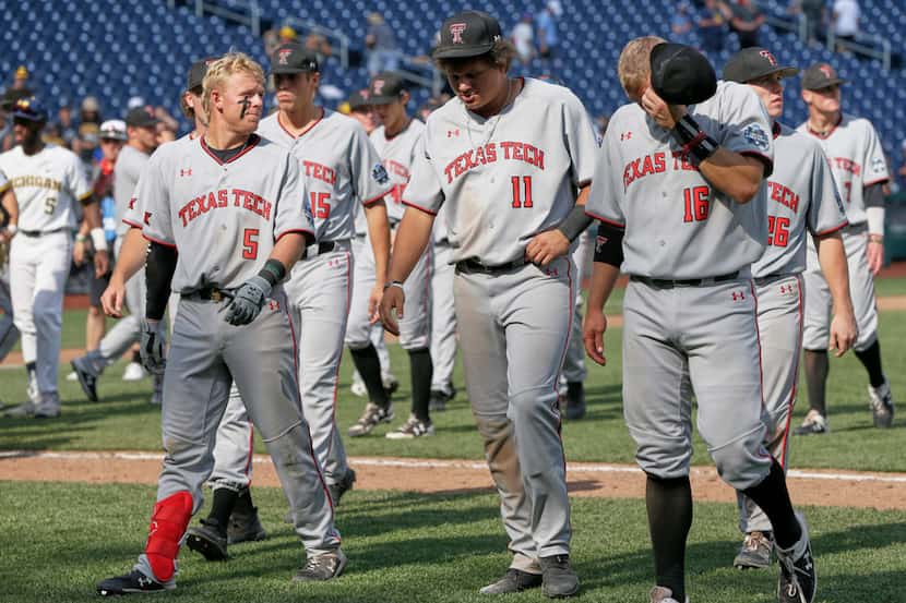 Texas Tech players walk off the field following their loss to Michigan in an NCAA College...