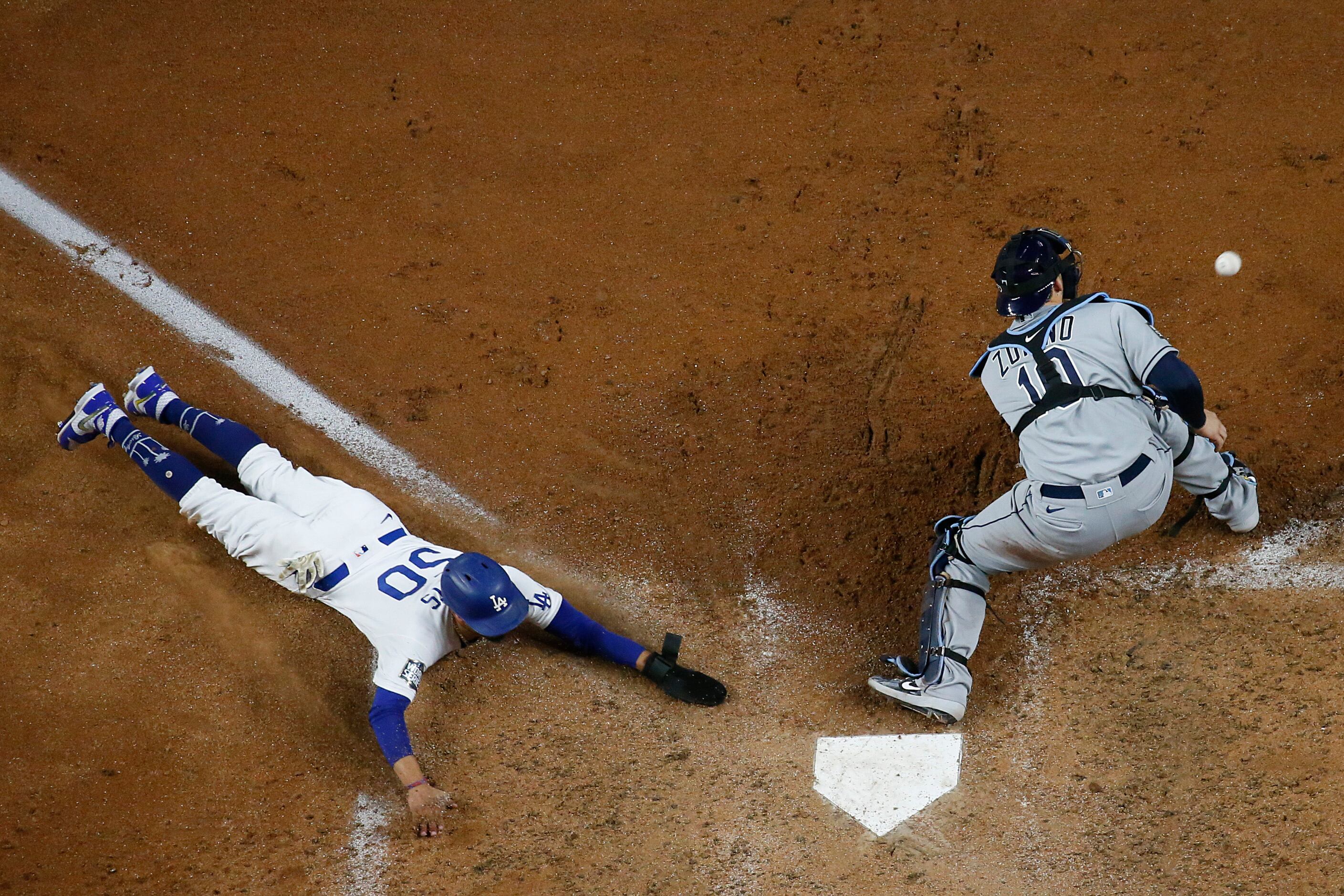 Los Angeles Dodgers right fielder Mookie Betts  scores past Tampa Bay Rays catcher Mike...