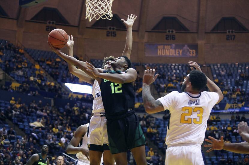 Baylor guard Jared Butler (12) shoots while defended by West Virginia forward Emmitt...