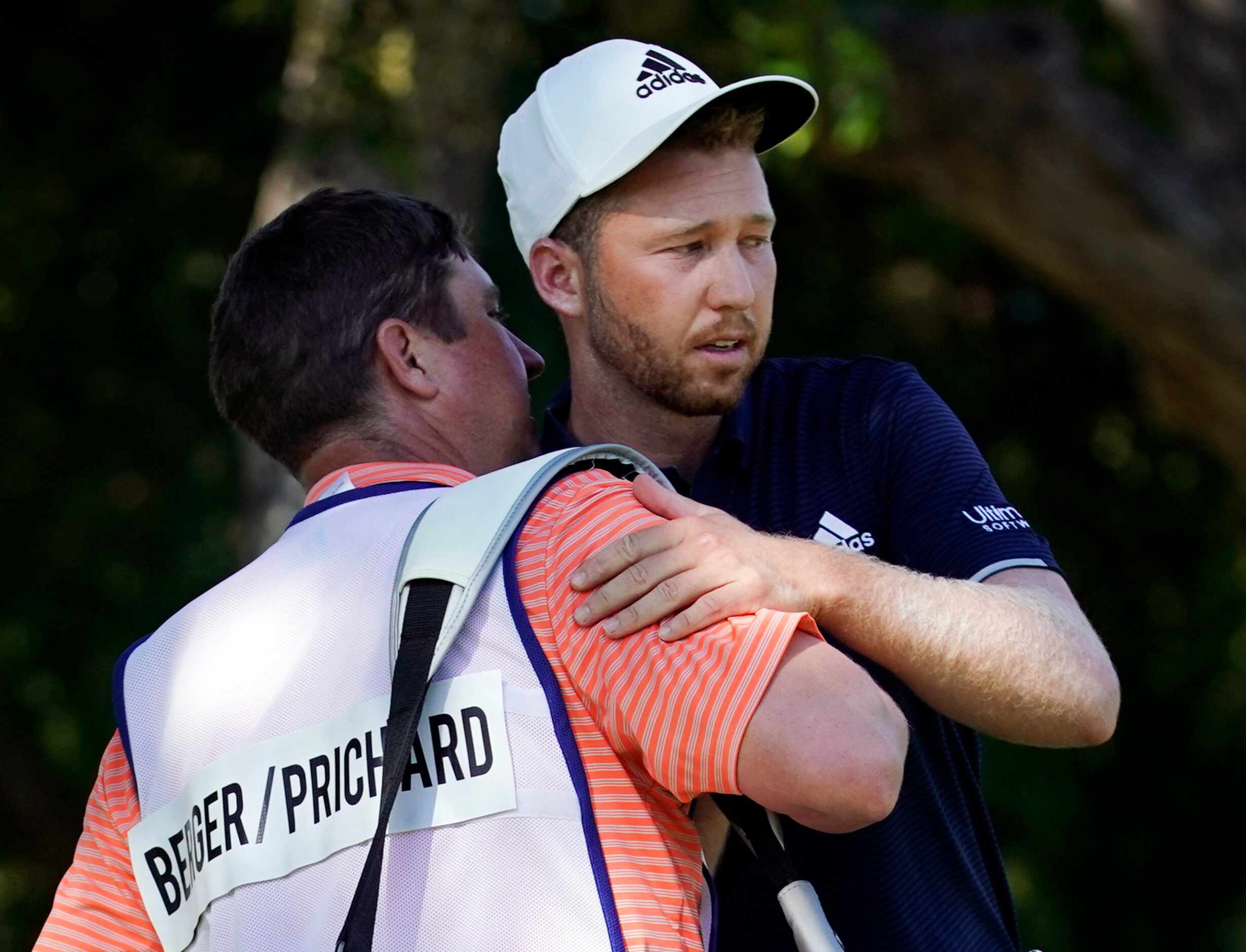 PGA Tour golfer Daniel Berger (right) is congratulated by his caddie Grant Barry after...