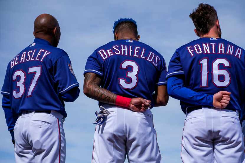 Texas Rangers third base coach Tony Beasley (37), outfielder Delino DeShields (3) and...