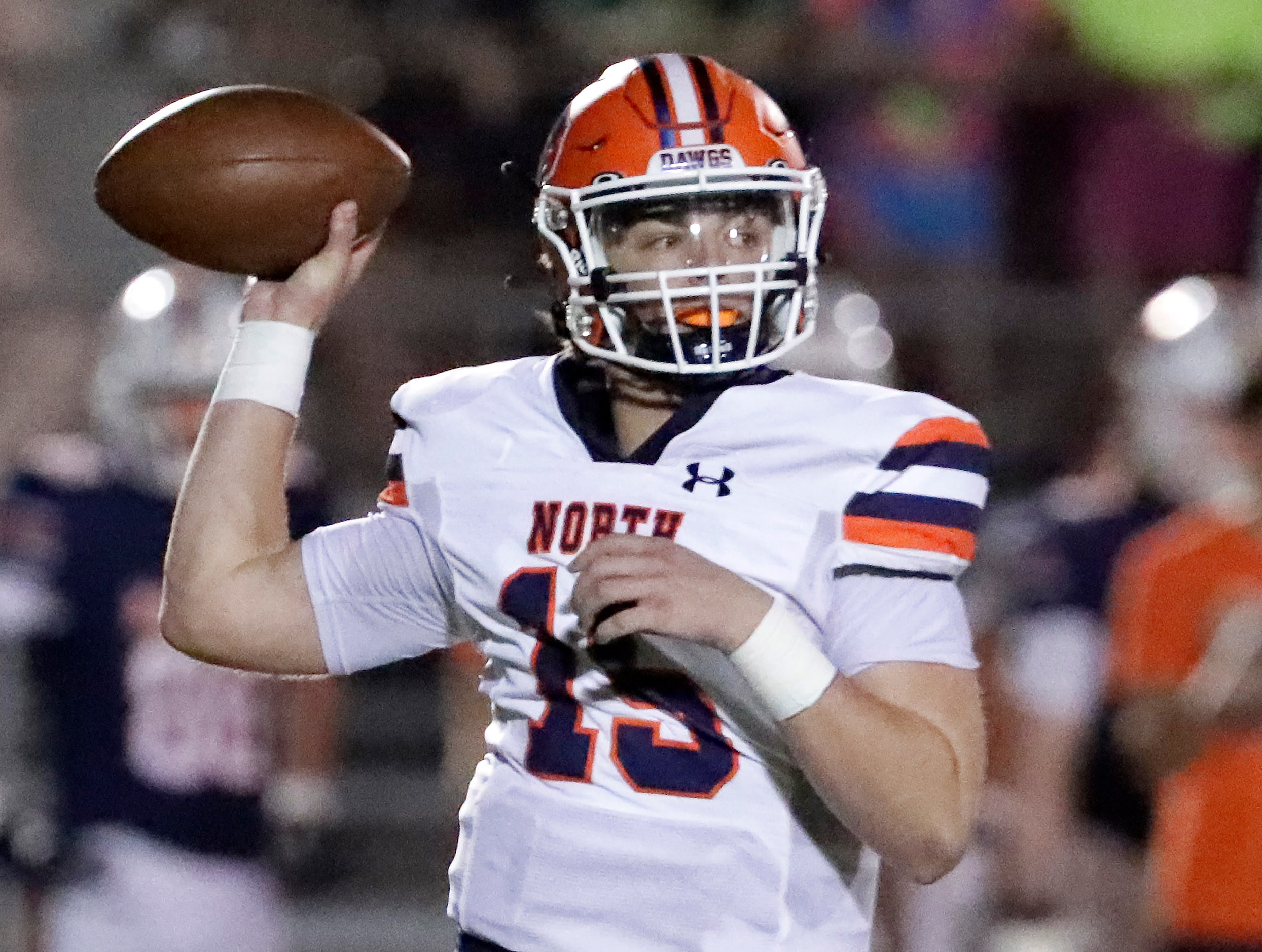 McKinney North High School quarterback Brooks Nelson (15) throws a pass during the first...