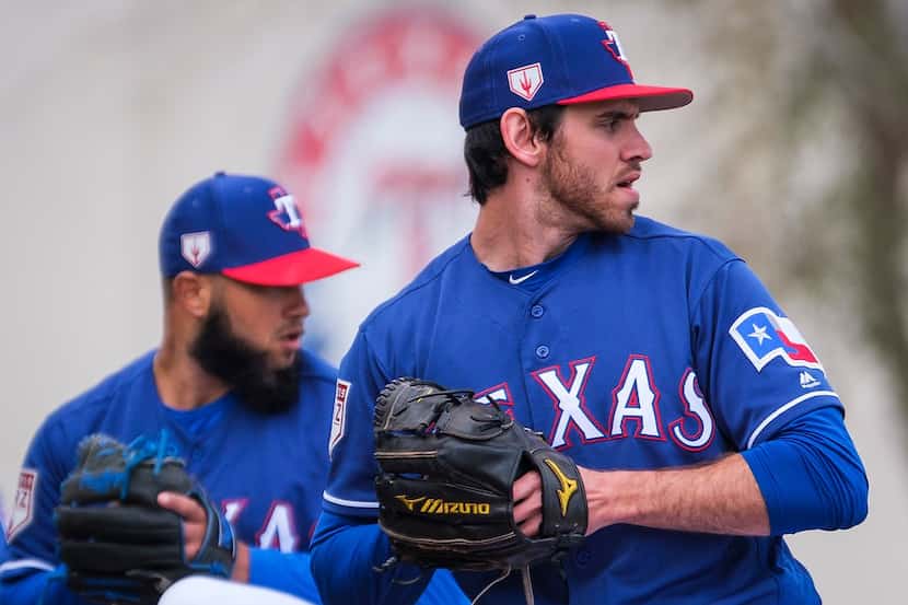 Texas Rangers pitchers Jordan Romano (front) and Richelson Pena throw in the bullpen during...