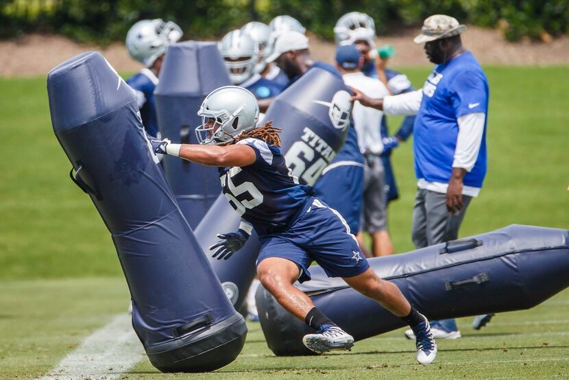 Dallas Cowboys defensive end Austin Larkin (65) runs a drill during the team's minicamp at...