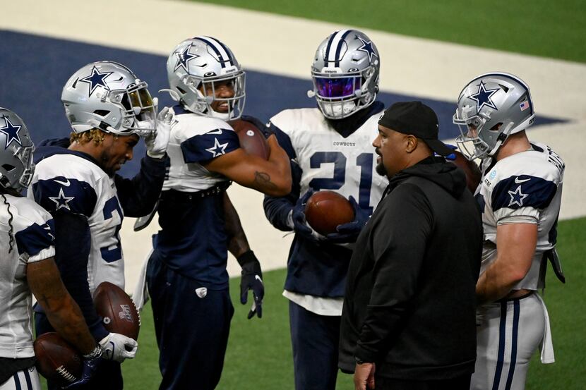 Dallas Cowboys running backs coach Skip Peete talks to the running backs during Dallas...