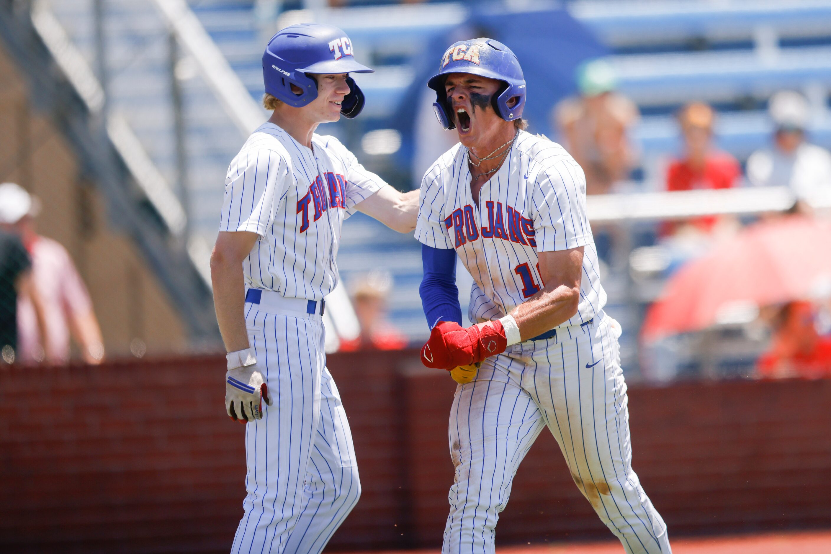 Trinity Christian’s Samuel Jenkins (10) celebrates after sliding into home in the fourth...