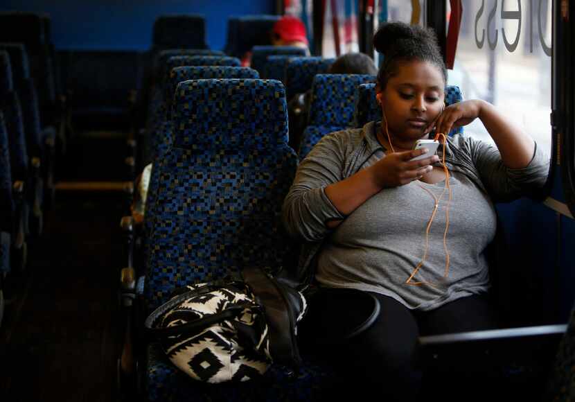 Saliana Girmai waits aboard the Metro ArlingtonXpress bus at College Park Center in...