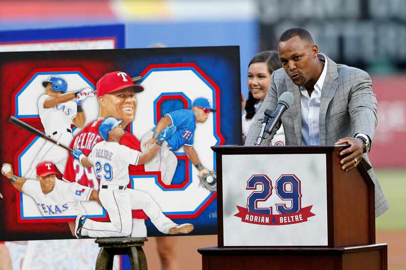 Retired player Adrian Beltre, right, speaks during a jersey retirement ceremony for him...