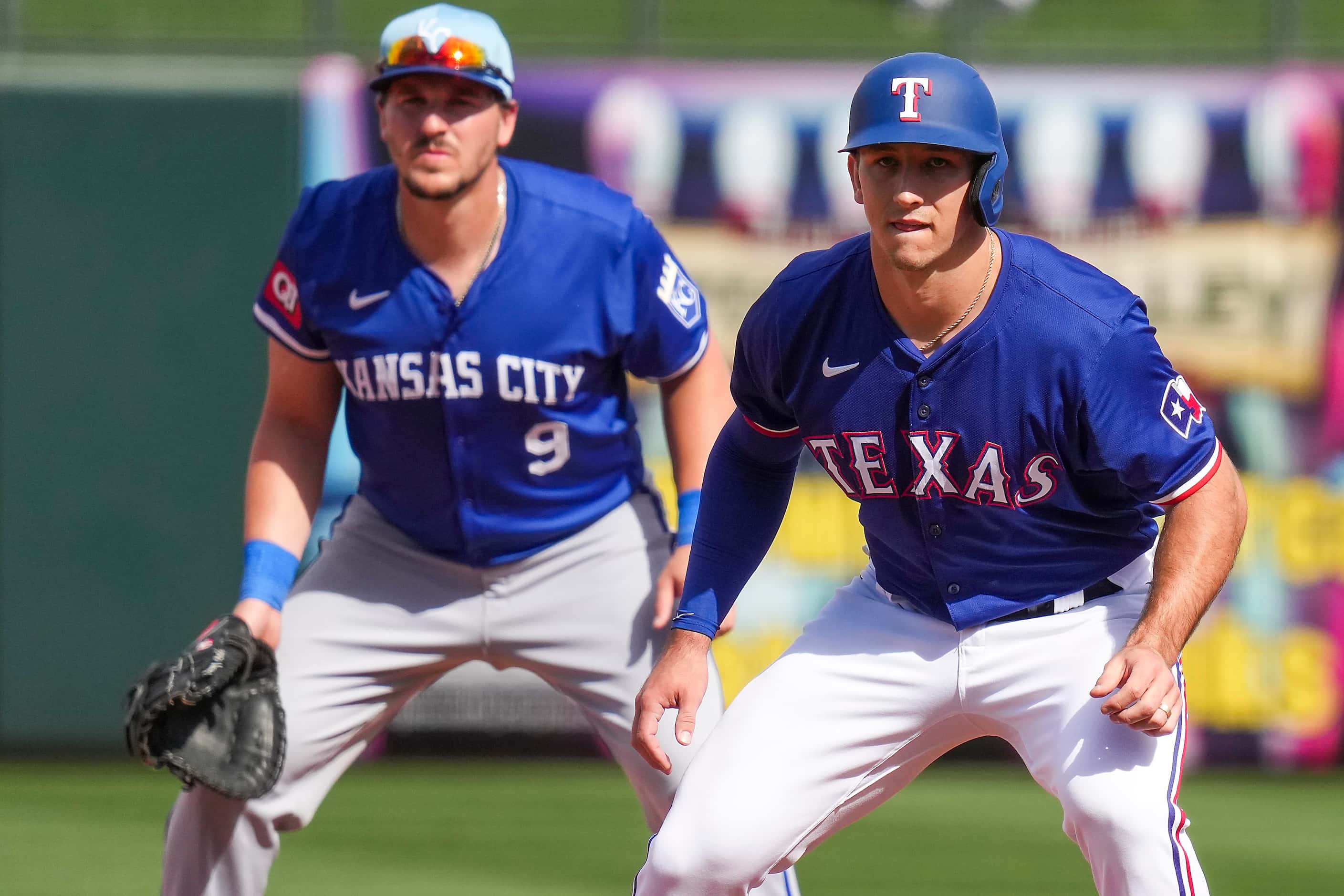 Texas Rangers outfielder Wyatt Langford takes a lead from first in front of Kansas City...