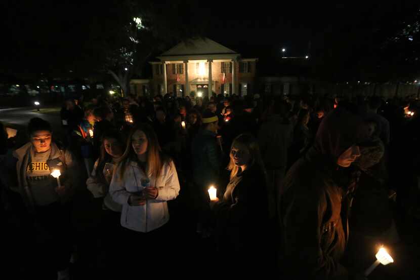 Baylor students and alumni hold a candlelight vigil outside the home of Baylor University...