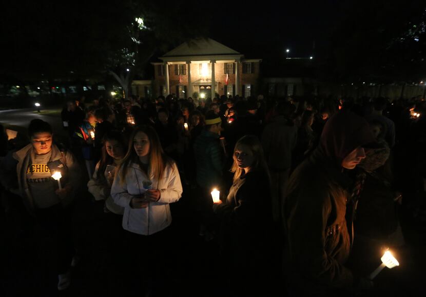 Baylor students and alumni hold a candlelight vigil outside the home of Baylor University...