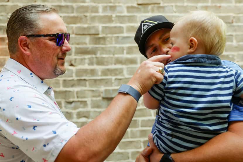 Incumbent state Rep. Justin Holland, R-Rockwall, (left), interacts with 14-month-old Rawley...