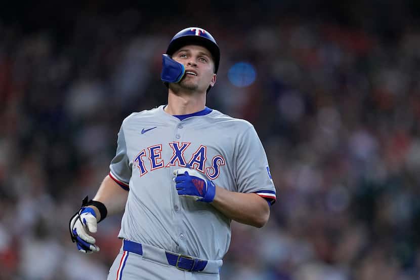Texas Rangers' Corey Seager reacts after flying out during the fifth inning of a baseball...
