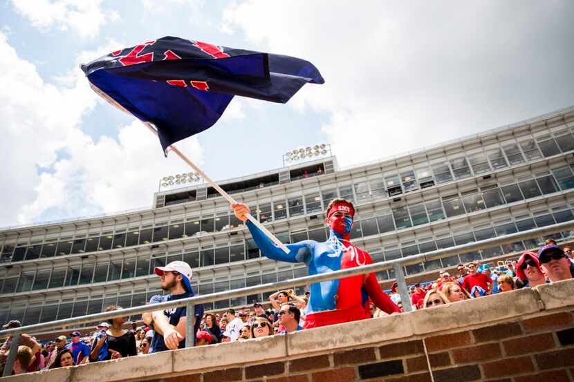 SMU fan Kyle Skipper waves an SMU flag from the stands during the first half of their spring...