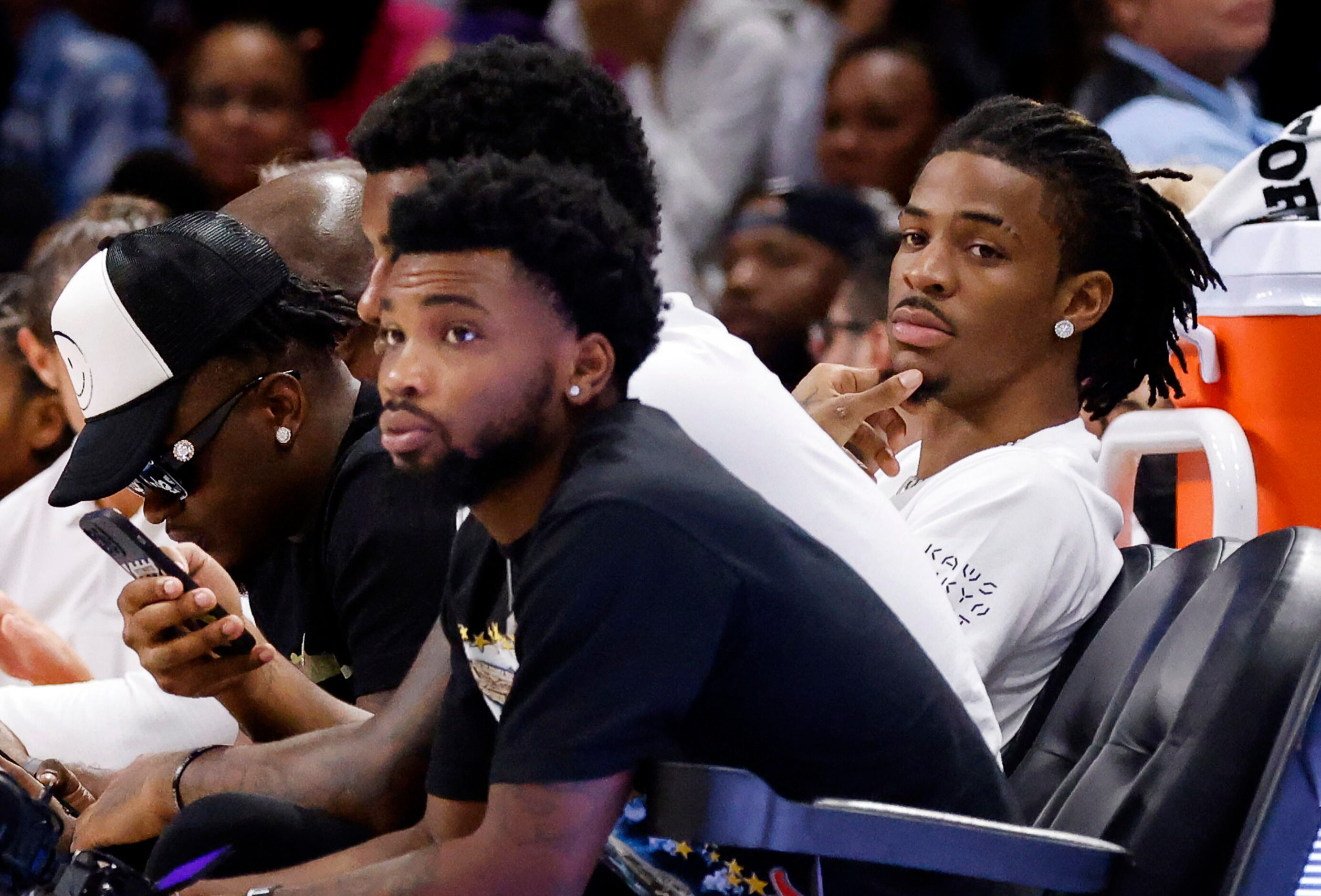 Memphis Grizzlies star guard Ja Morant (right) watches the Dallas Wings and Connecticut Sun...