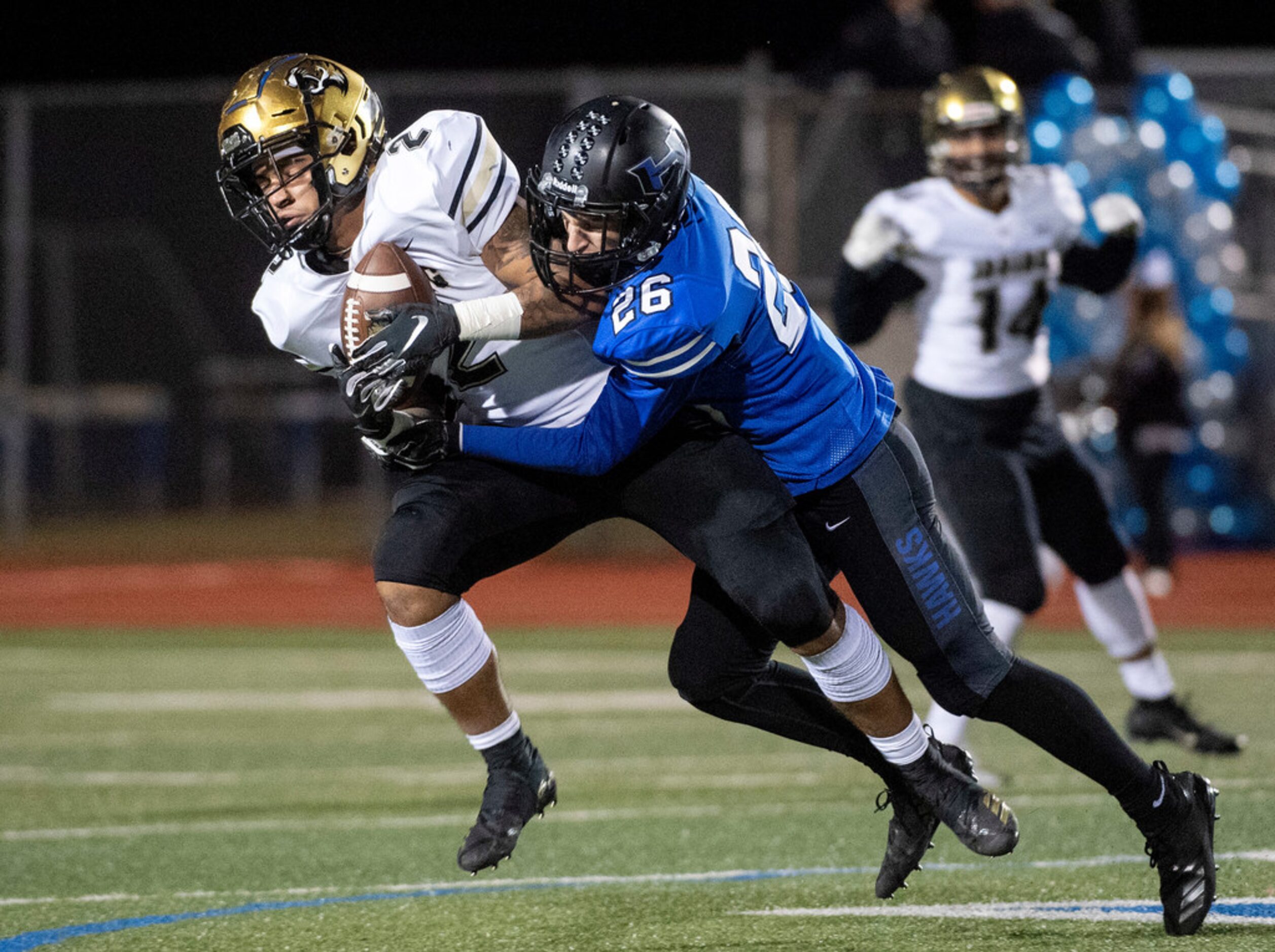 Hebron senior defensive back Kevin Waida (26) takes down Irving senior running back Trey...