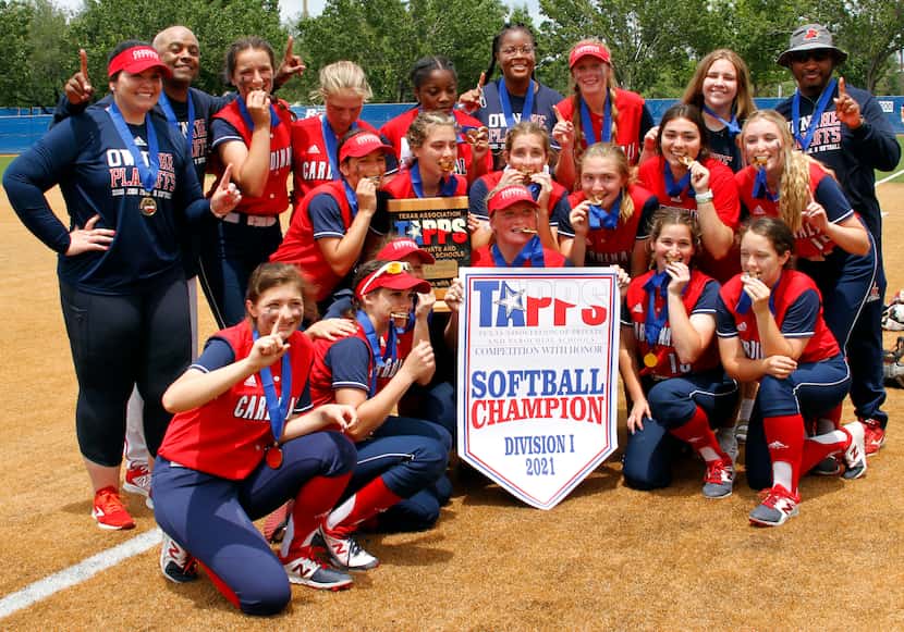 Plano John Paul ll players and coaches pose with their championship softball medals and...