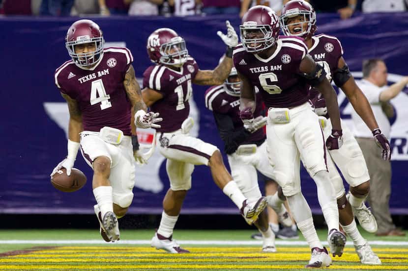 Texas A&M defensive back Noel Ellis and the rest of the Aggie defense celebrates after...