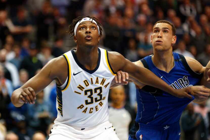 Indiana Pacers center Myles Turner (33) and Dallas Mavericks forward Dwight Powell, right,...