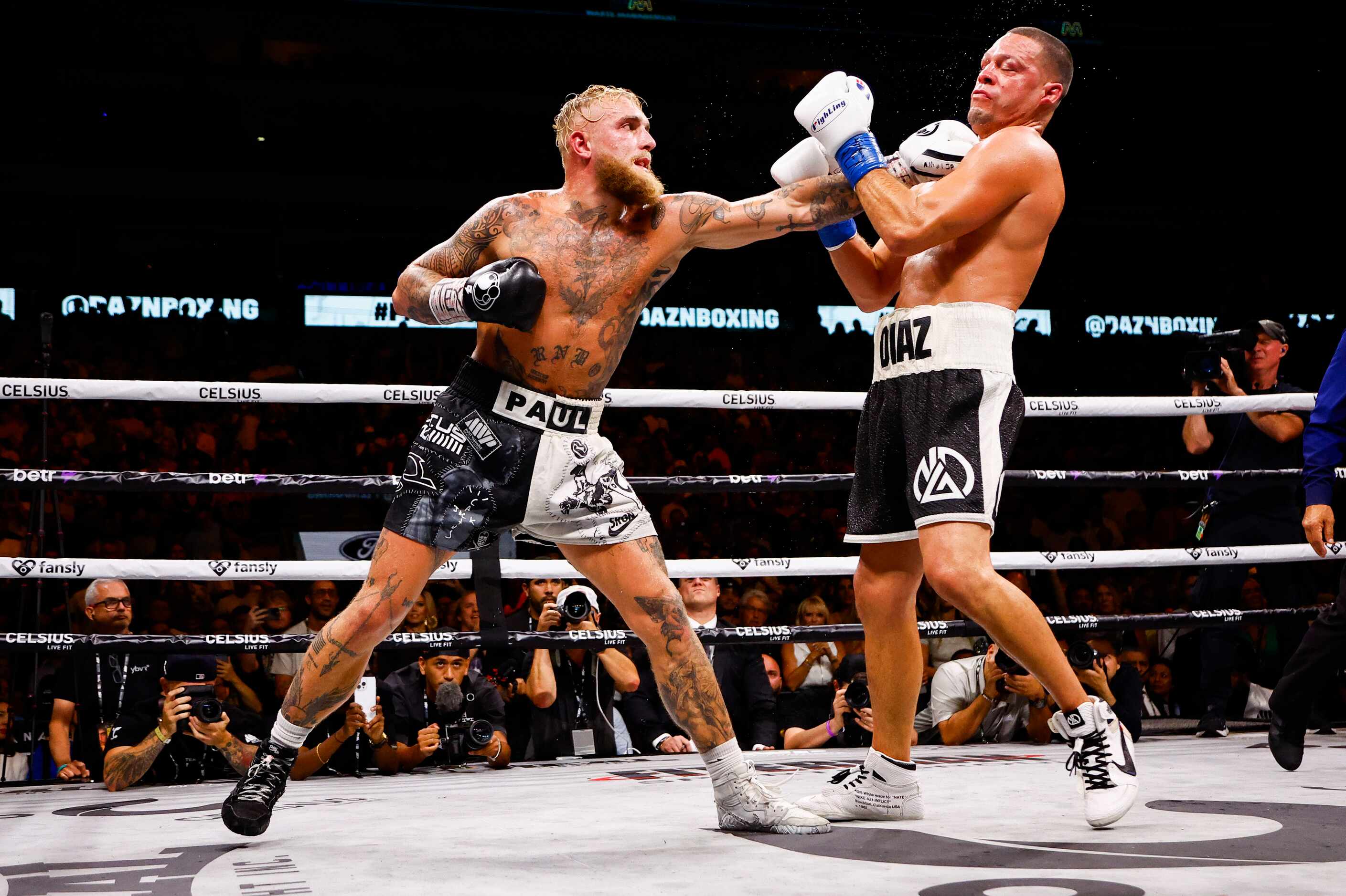 Jake Paul, left, lands a punch on Nate Diaz during a boxing match in Dallas, Saturday,...