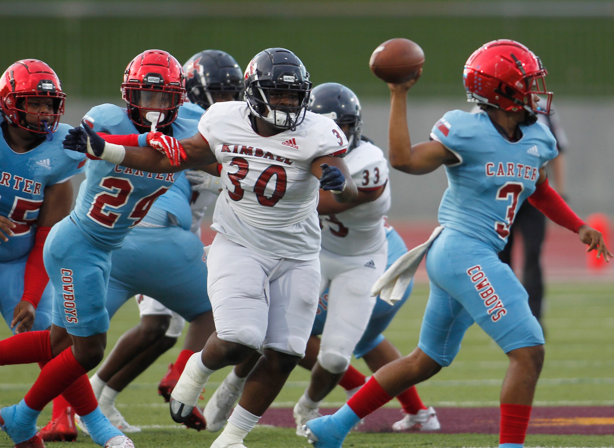 Dallas Carter quarterback Qualon Robinson (3) gets off a pass as he is pursued by Dallas...