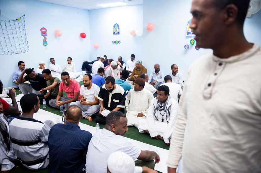 People gather to break their fast at the Ethiopian Community Center In Garland, Texas on...