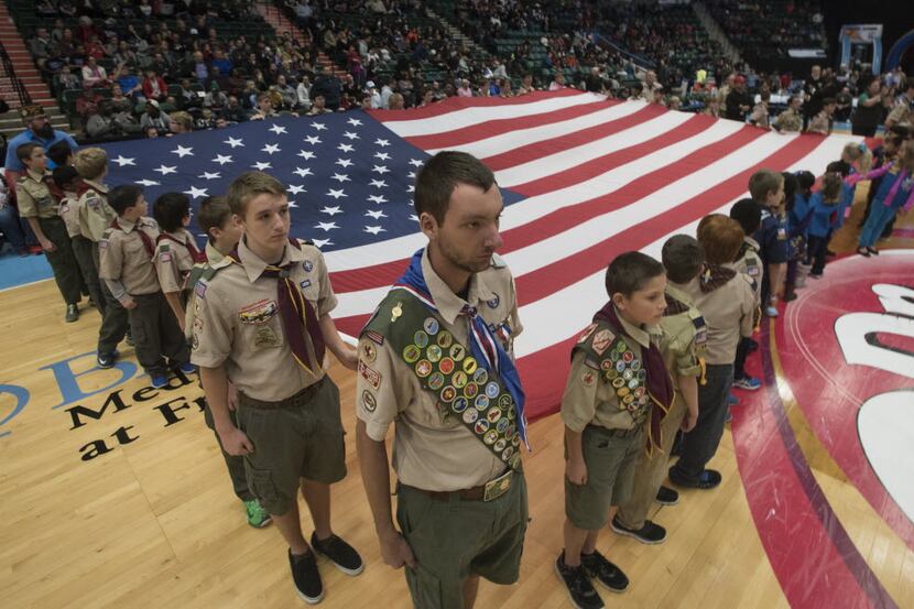 Boy Scouts hold a large American flag during a ceremony by the Texas Legends honoring the...