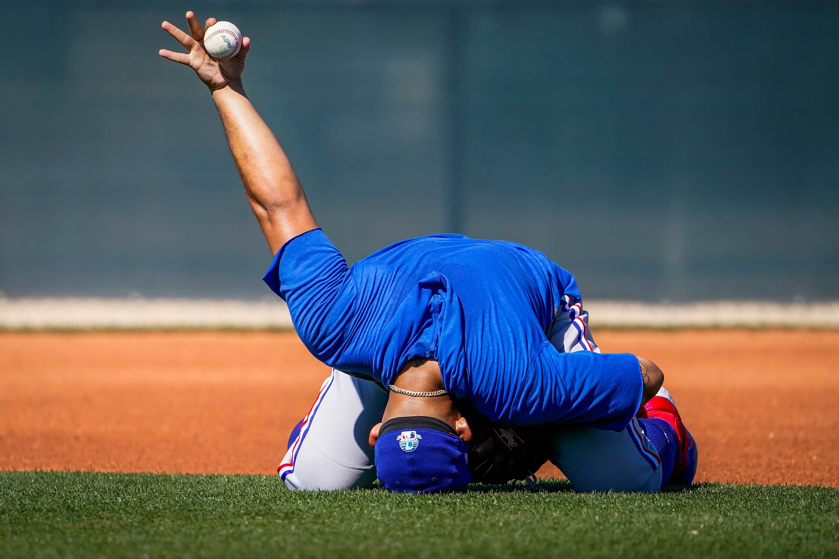 Texas Rangers second baseman Rougned Odor show off the ball after making a catch in a...