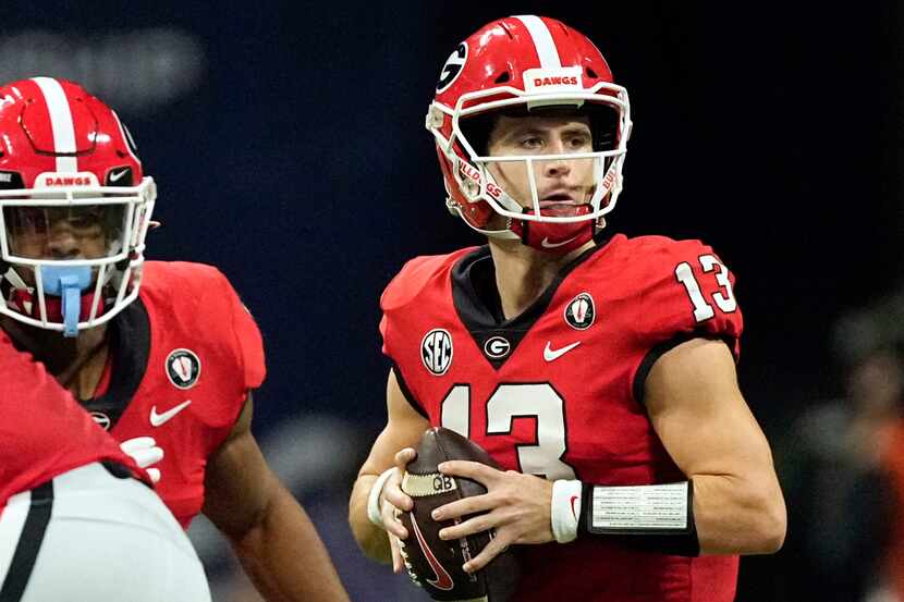 FILE - Georgia quarterback Stetson Bennett (13) looks for an open receiver in the first half...