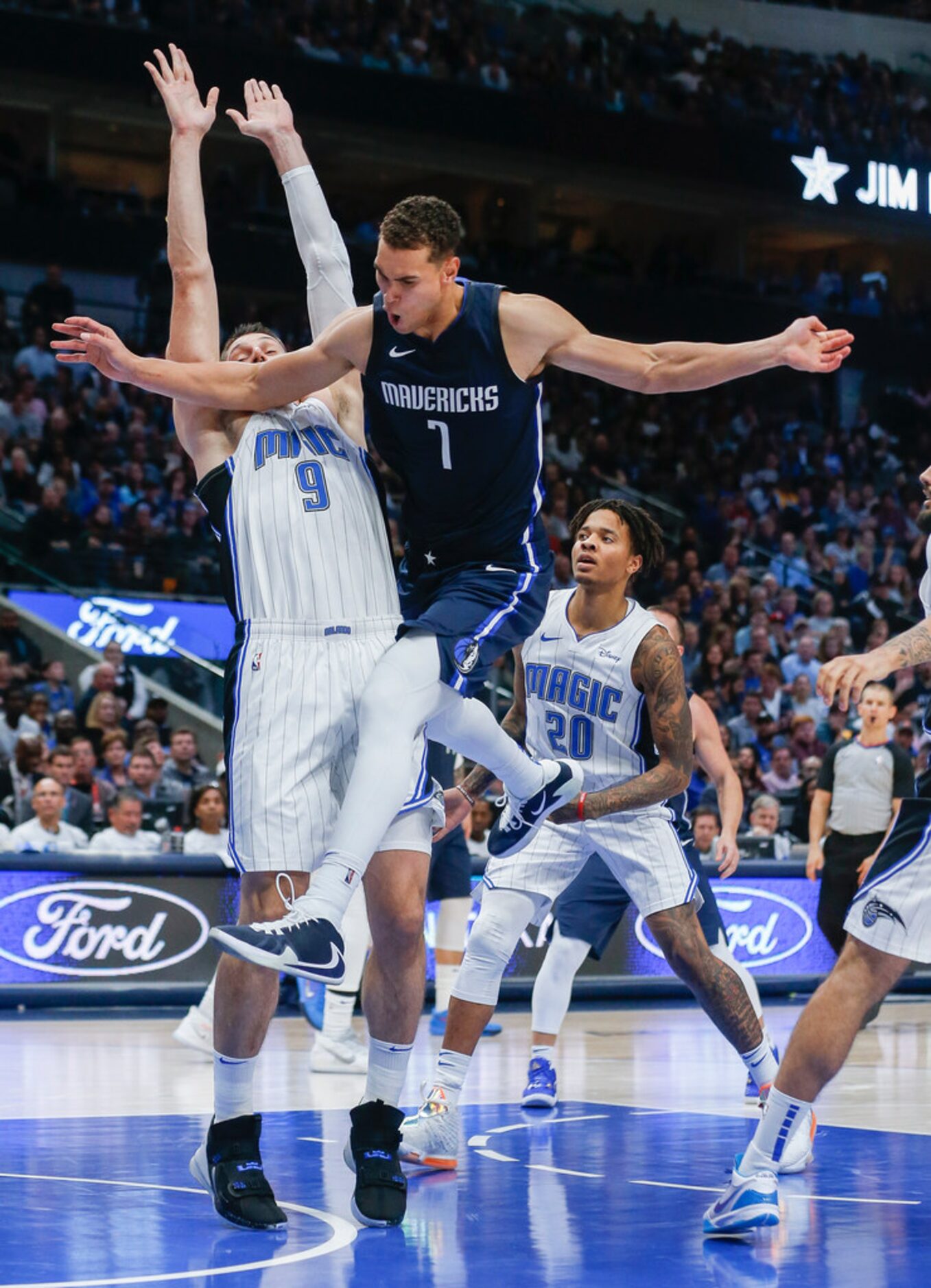 A shot by Dallas Mavericks forward Dwight Powell (7) is blocked by Orlando Magic center...