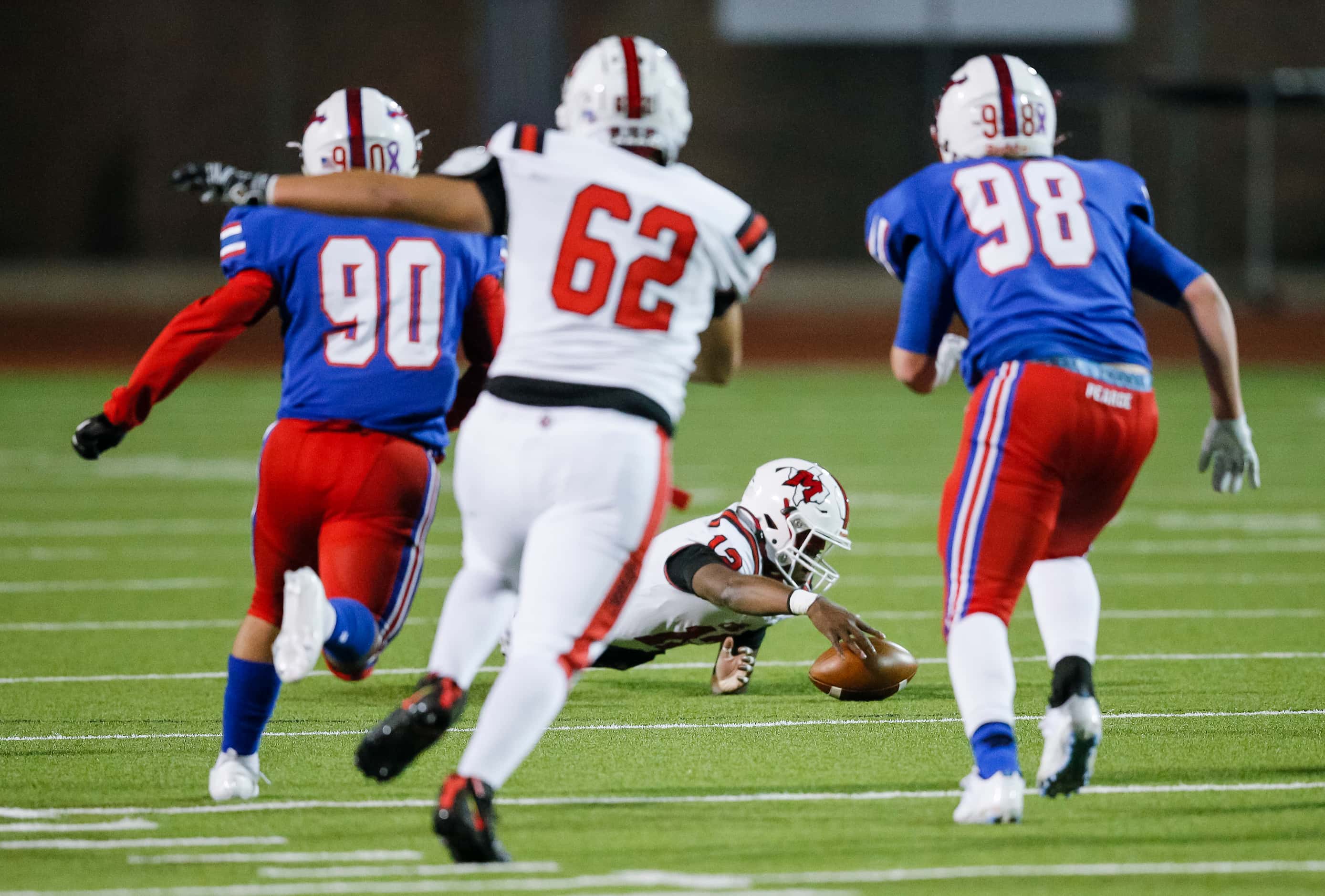 Irving MacArthur sophomore quarterback Kylale Flye (12) recovers the ball after a bad snap...