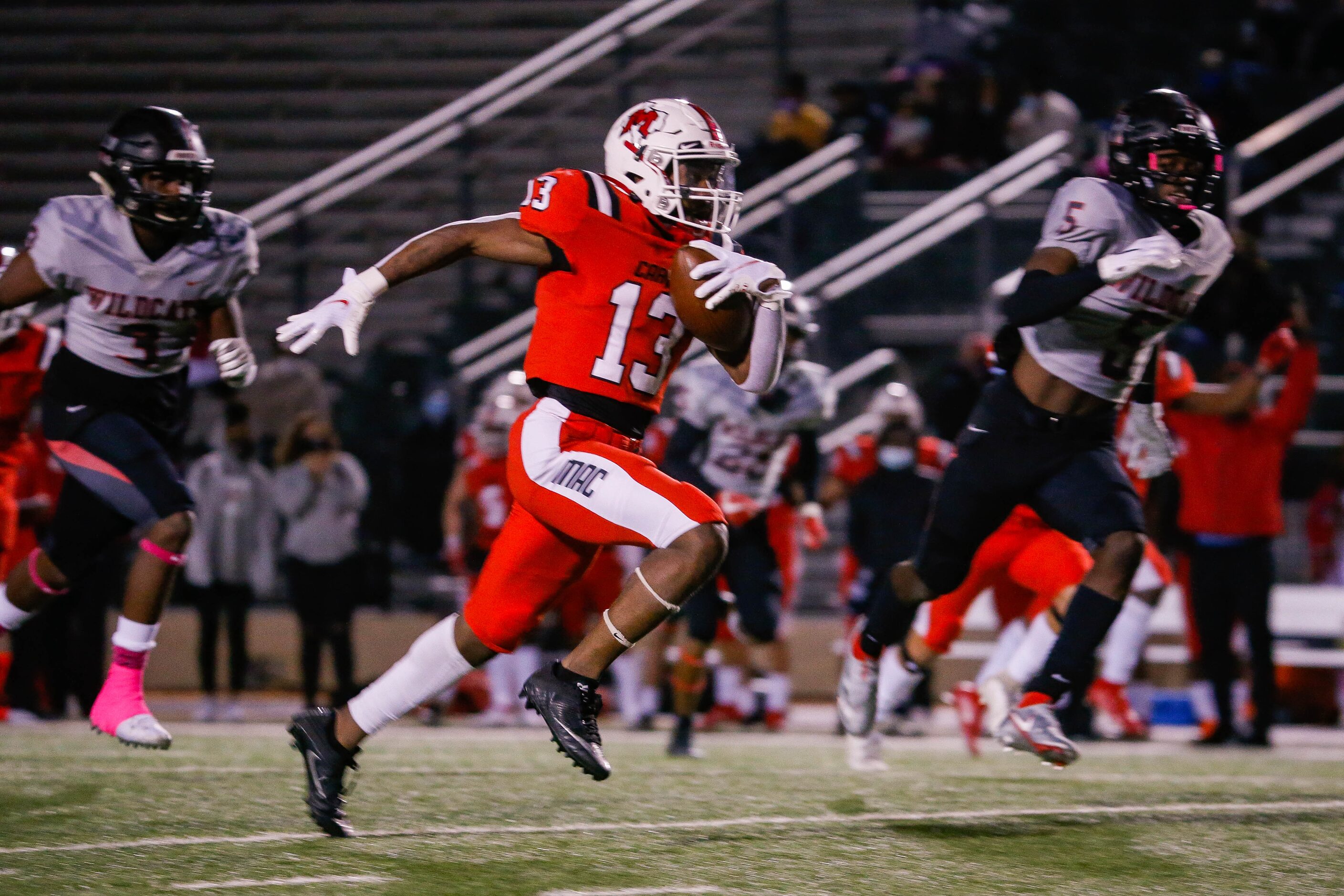 Irving MacArthur's Davison Morris (13) slips past the  Lake Highlands' defense for a...