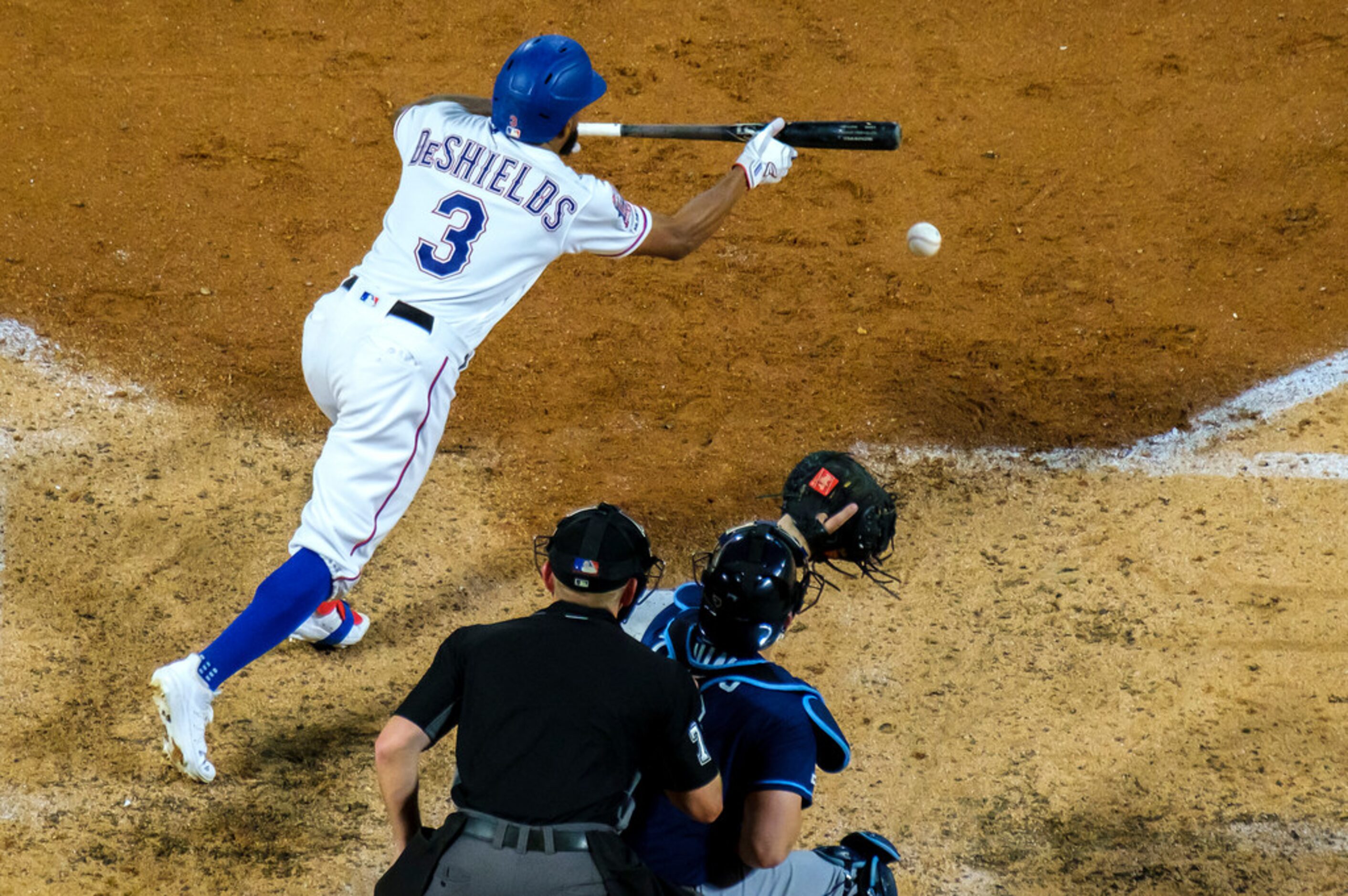 Texas Rangers outfielder Delino DeShields (3) bunts for a single during the fourth inning...