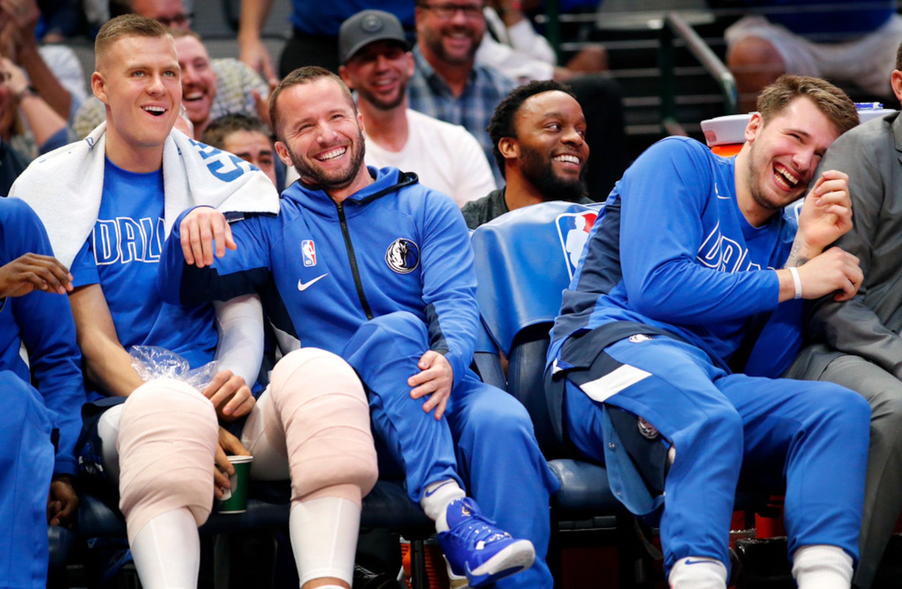 After a continuous chant of J-J, Dallas Mavericks guard J.J. Barea (center) leapt up off the...