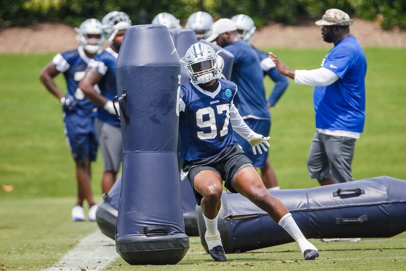 Dallas Cowboys defensive end Taco Charlton (97) runs a drill during the team's minicamp at...