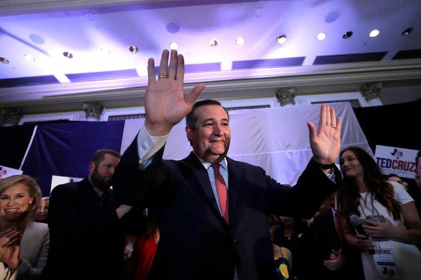 Sen. Ted Cruz, R-Texas, raises his hands while delivering his victory speech during an...