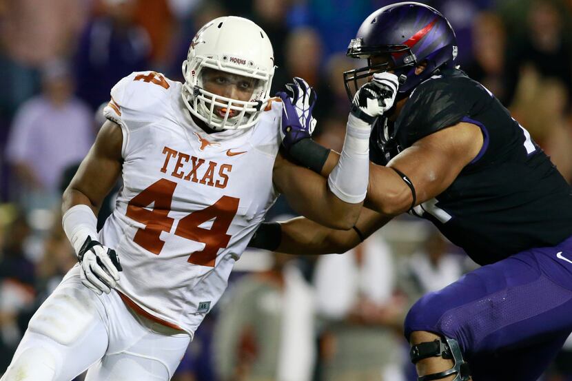 Halapoulivaati Vaitai (74) blocks Texas' Jackson Jeffcoat in 2013. TCU head coach Gary...