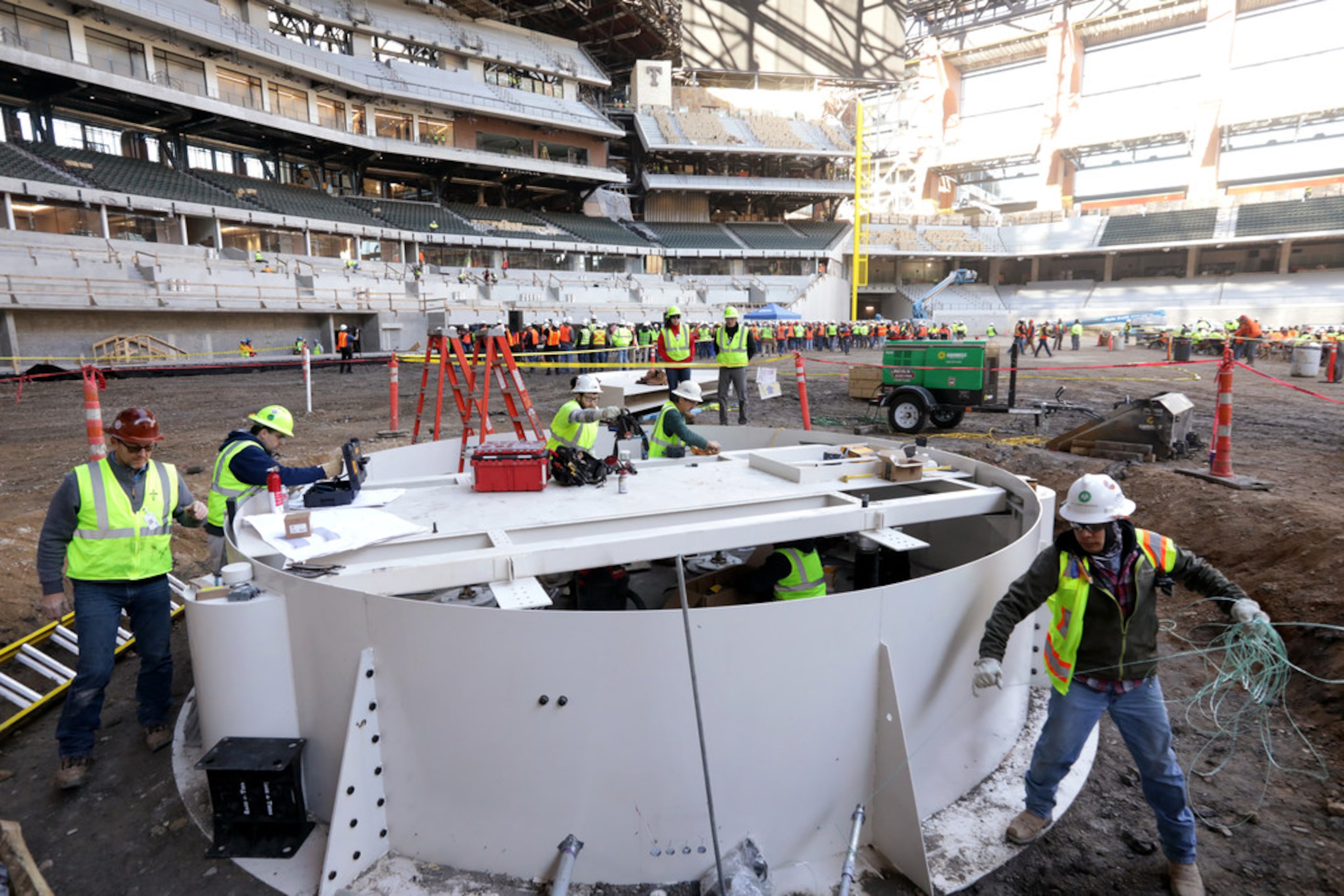 Workers continue construction on the pitcher's mound foundation at Globe Life field in...