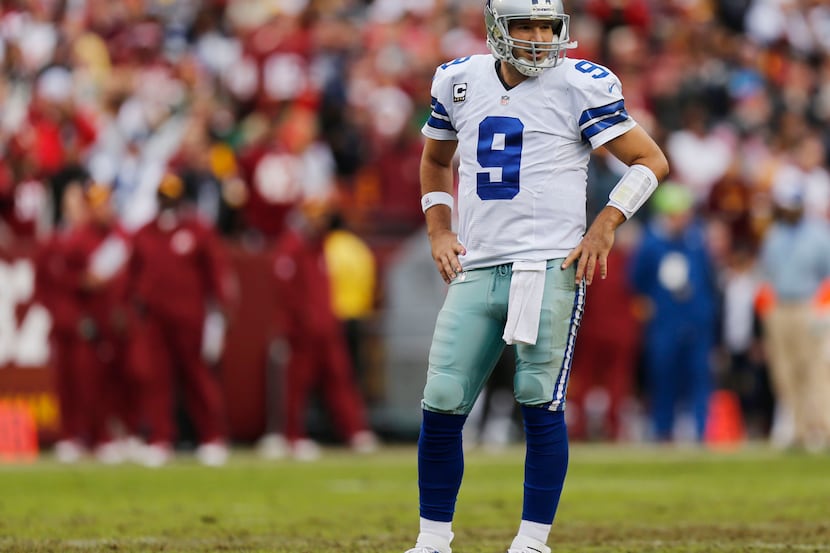 Dallas QB Tony Romo yells as he and C Phil Costa run off the field after a sack in the first...