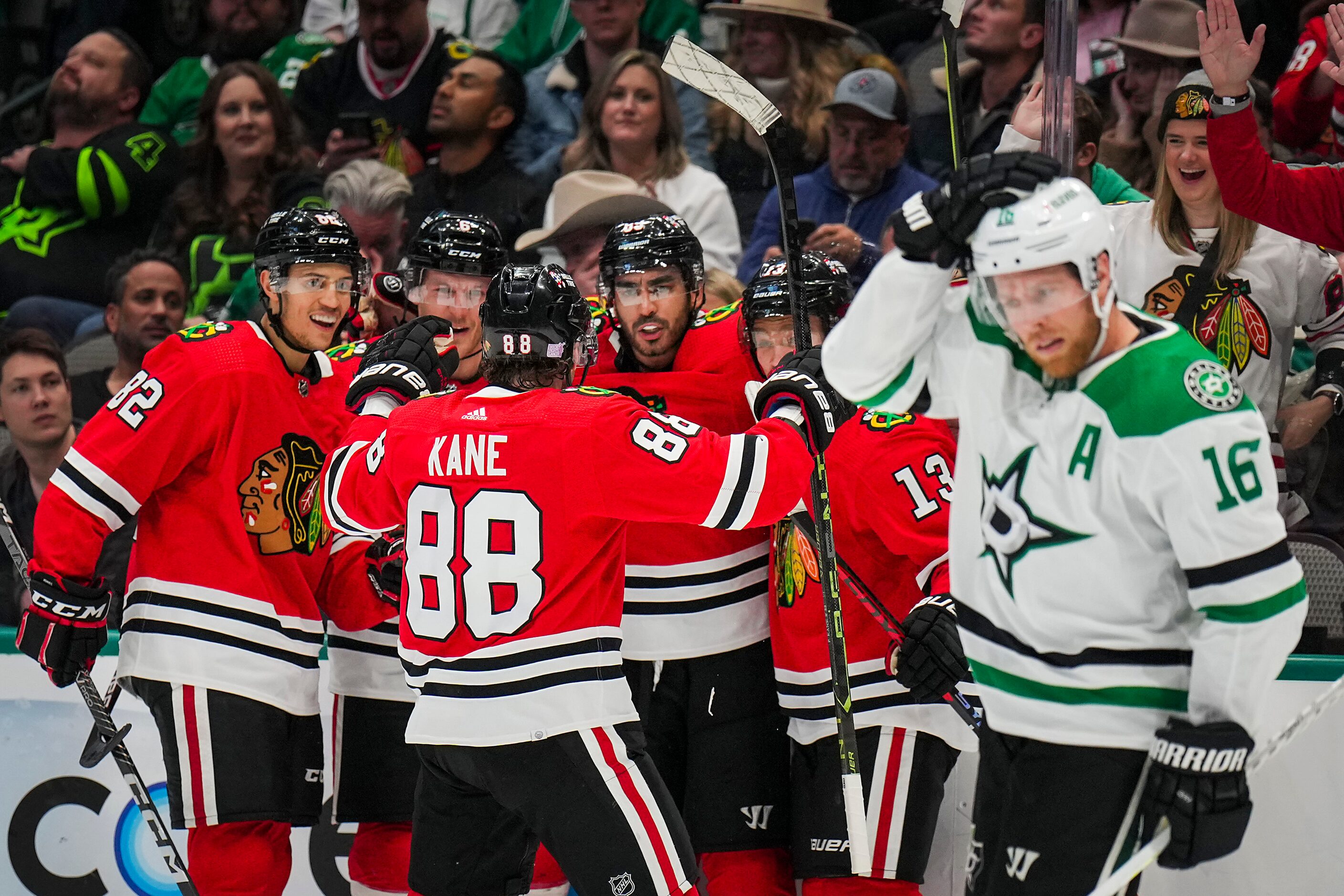 Chicago Blackhawks center Andreas Athanasiou (facing) celebrates with right wing Patrick...