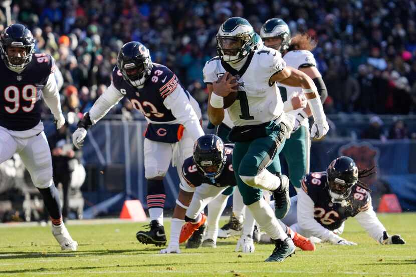 Philadelphia Eagles' Jalen Hurts runs for a touchdown during the first half of an NFL...