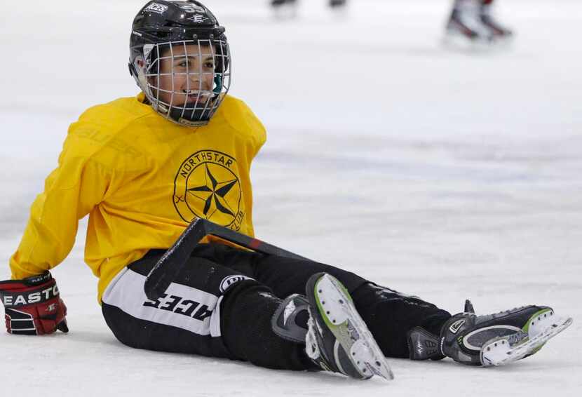 
Thomas Heather  falls on the ice. The number of kids playing hockey in Allen grew 20...