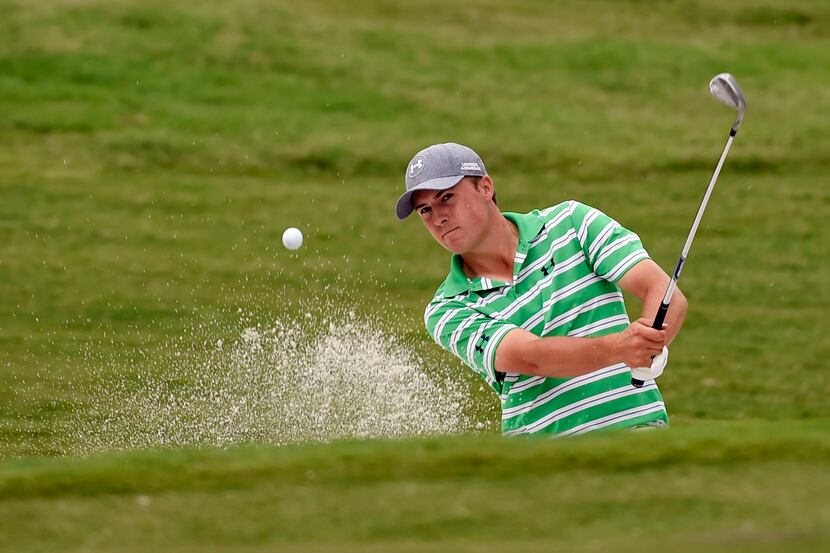 Jordan Spieth hits out of a sand trap on the 1st green during the second round of the Crowne...