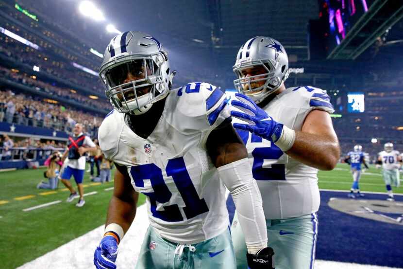 ARLINGTON, TX - DECEMBER 26: Ezekiel Elliott #21 of the Dallas Cowboys celebrates with...