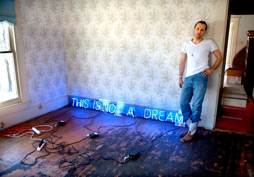 Artist Chivas Clem photographed with "This Is Not A Dream, blue neon," 1997. Photographed at...