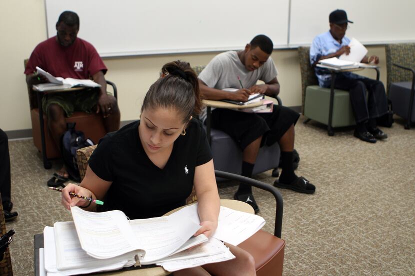 Grecia Gonzales, 22, of Dallas, works on a pre-algebra final exam at the Eastfield College...