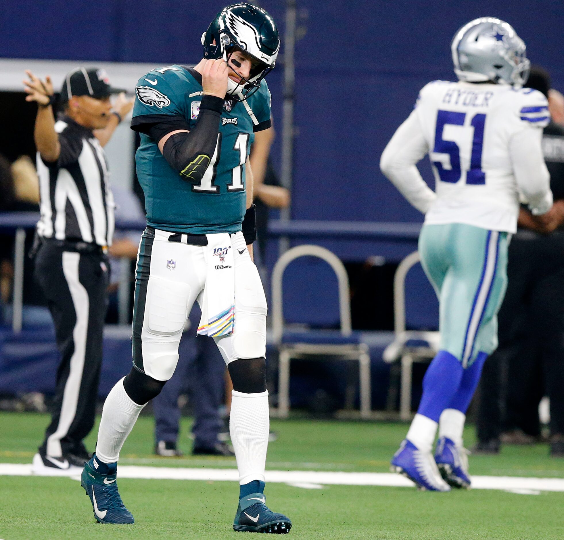 Philadelphia Eagles quarterback Carson Wentz (11) walks to the sideline after throwing a...