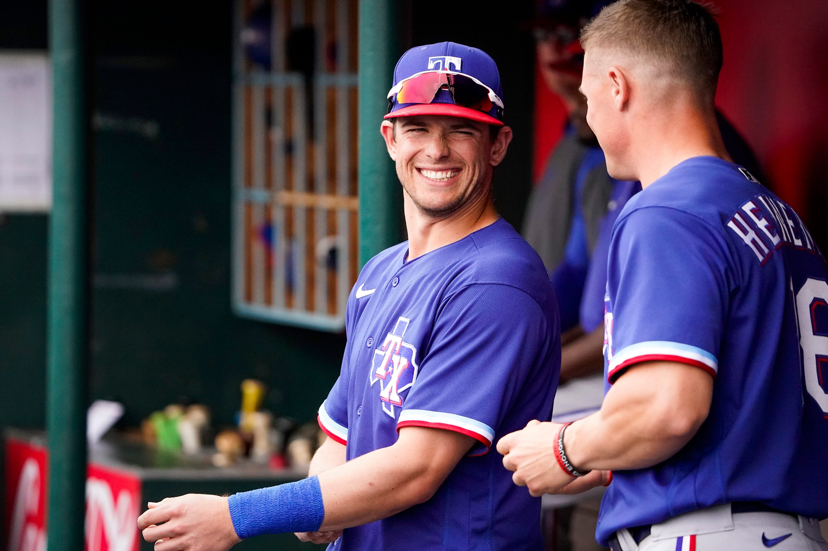 Texas Rangers infielder/outfielder Nick Solak laughs with outfielder Scott Heineman in the...