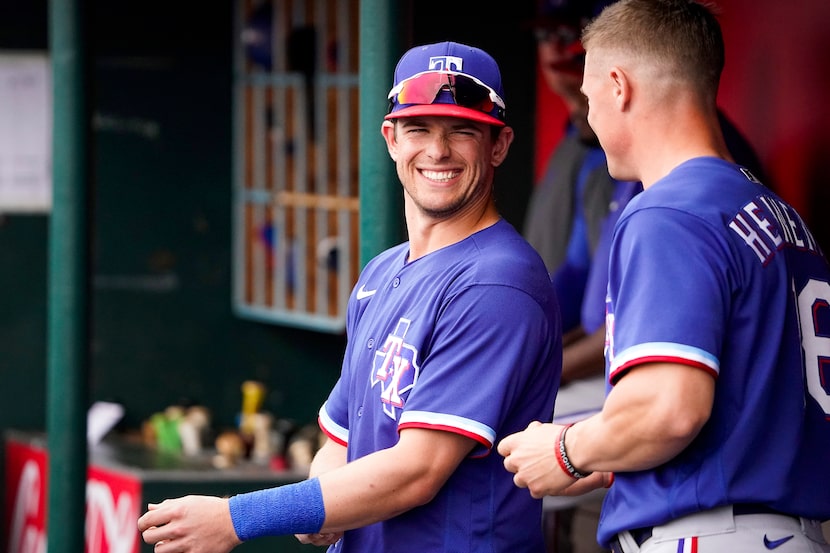 Texas Rangers infielder/outfielder Nick Solak laughs with outfielder Scott Heineman in the...